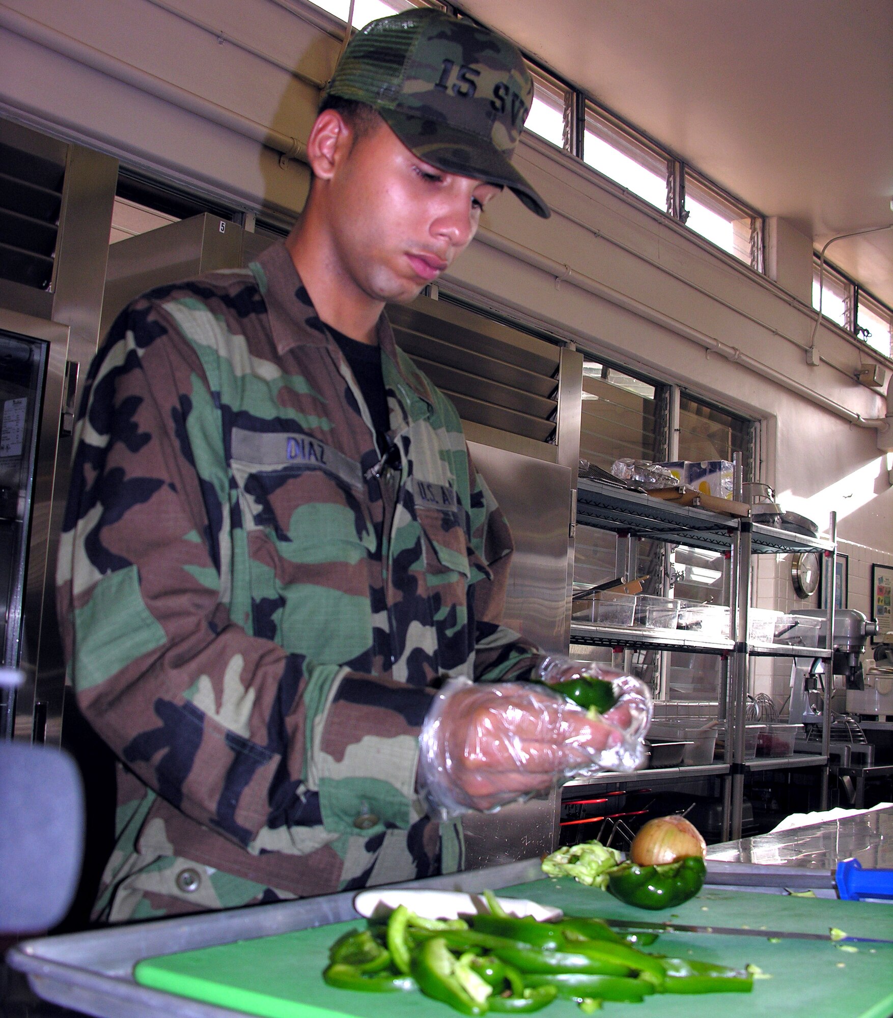 Airman Basic Alex Diaz takes the seeds out of bell peppers at the Hale' Aina Dining Facility at Hickam Air Force Base, Hawaii. (U.S. Air Force photo/Senior Airman Erin Smith)