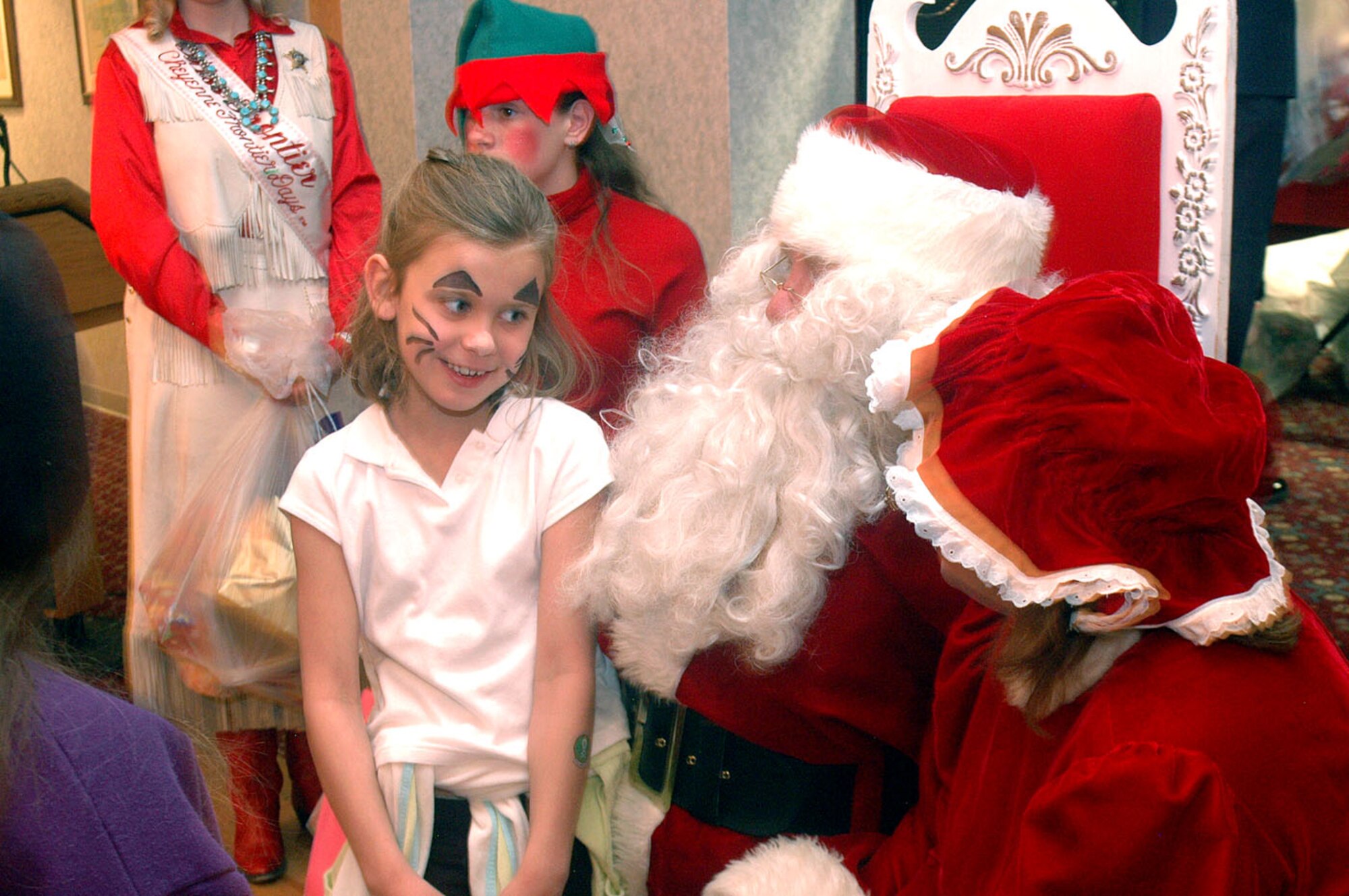 A local girl tells Santa and Mrs. Claus what she wants for Christmas in the Trail's End Club Saturday during Operation Provide Joy. OPJ is a holiday party for local children held every year at Trail's End.