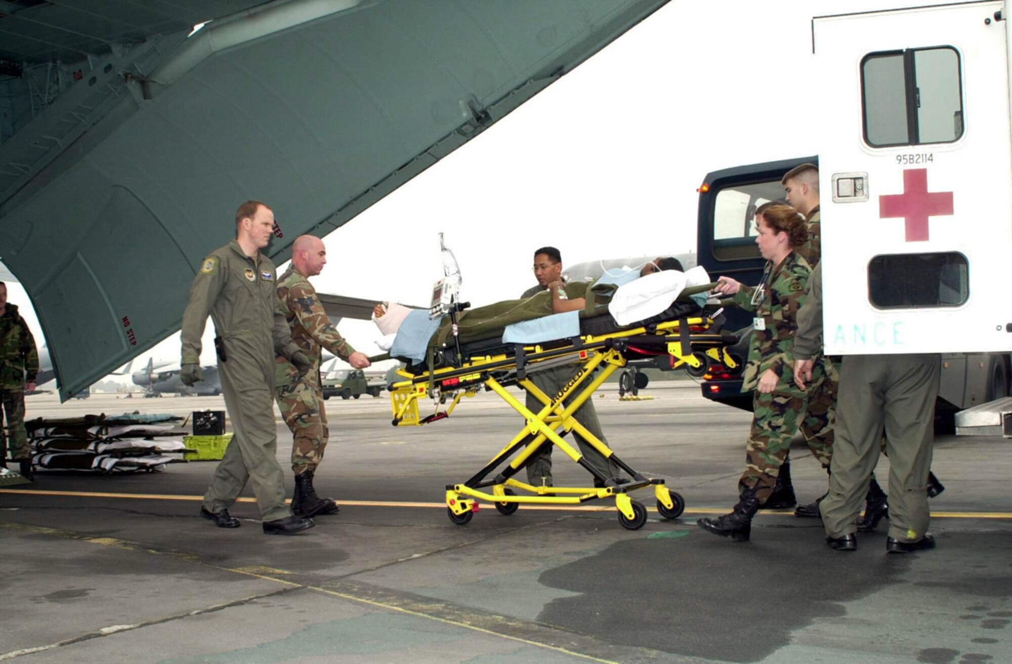 An injured service member is delivered to an awaiting aircraft for further transport to a medical care facility for treatment. 927th Aeromedical Staging Squadron (Air Force Reserve) personnel are often involved in the emergency treatment and transporting of injured individuals.