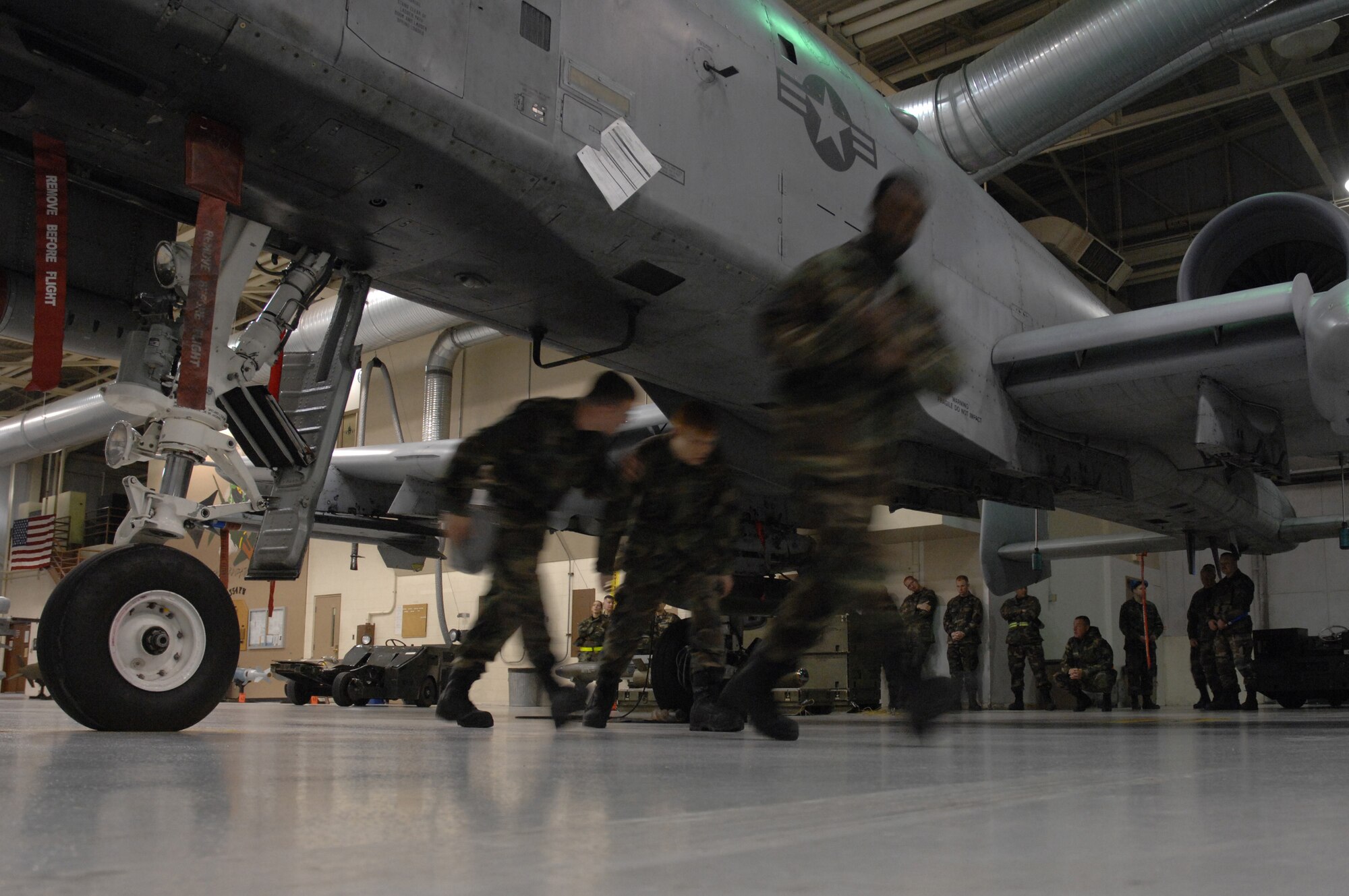 EIELSON AIR FORCE BASE, Alaska -- The team of Staff Sgt Michael Woroniecki (left), Senior Airman Vankeithin Simmons (right), and Joshua Gess (middle) move quickly under an A-10 Thunderbolt II to complete their portion of the Load Crew of the Quarter contest here on 15 December. The Airmen represent the 355th Aircraft Maintenance Unit (AMU) and the quarterly contest pitts the 18th AMU versus the 355th AMU. Both teams loaded 2 MK-82 low drag bombs and one AIM-9 sidewinder missile to their respective aircraft.
(U.S. Air Force Photo by Staff Sgt Joshua Strang)