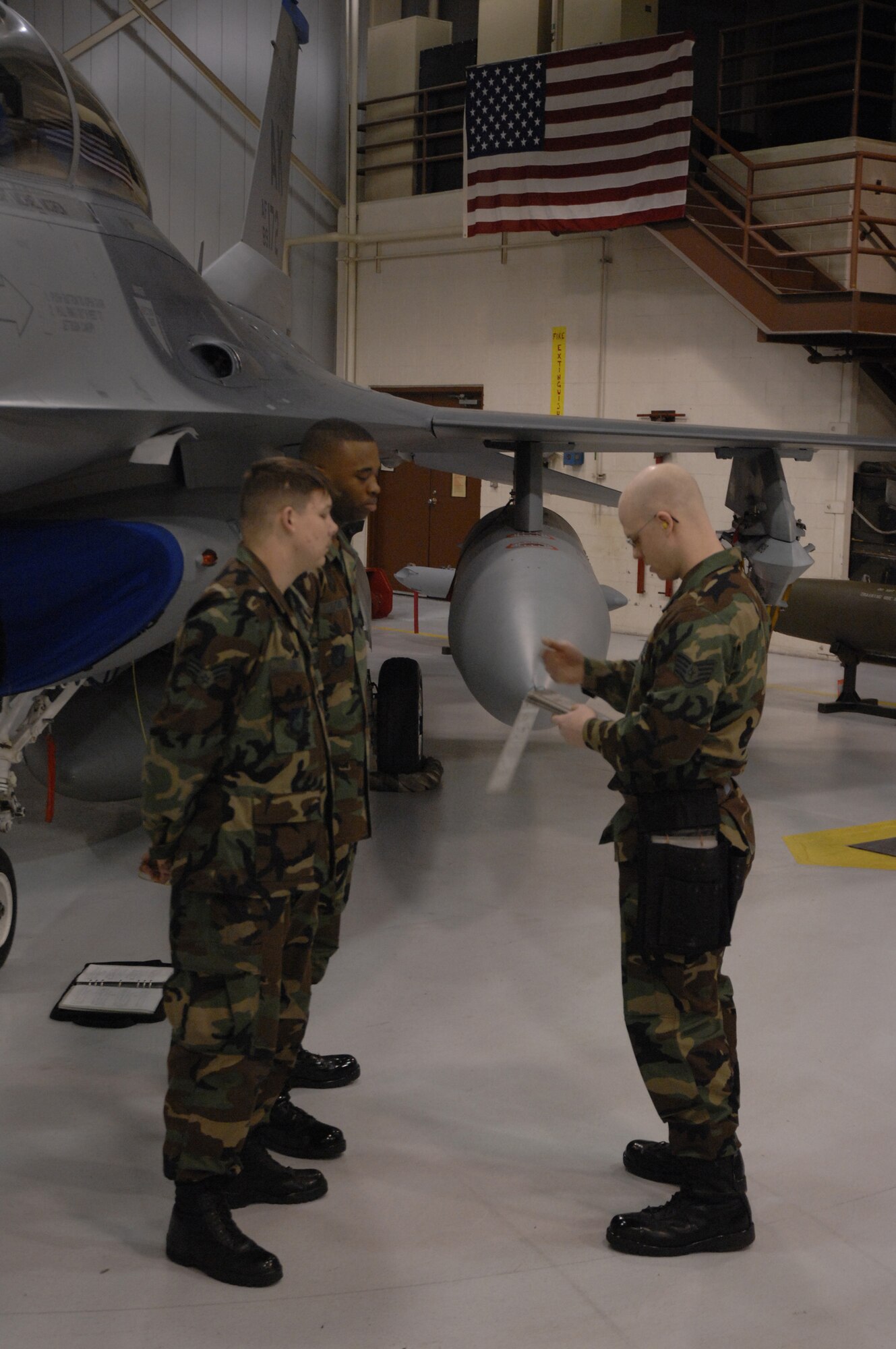 EIELSON AIR FORCE BASE, Alaska -- Staff Sgt Aaron Slay (right) briefs Senior Airman Michael Lee (front left) and Senior Airman Corneilius Cutler prior to the timed portion of the Load Crew of the Quarter contest here on 15 December. The Airmen represent the 18th Aircraft Maintenance Unit (AMU) and the quarterly contest pitts the 18th AMU versus the 355th AMU. Both teams loaded 2 MK-82 low drag bombs and one AIM-9 sidewinder missile to their respective aircraft.
(U.S. Air Force Photo by Staff Sgt Joshua Strang)