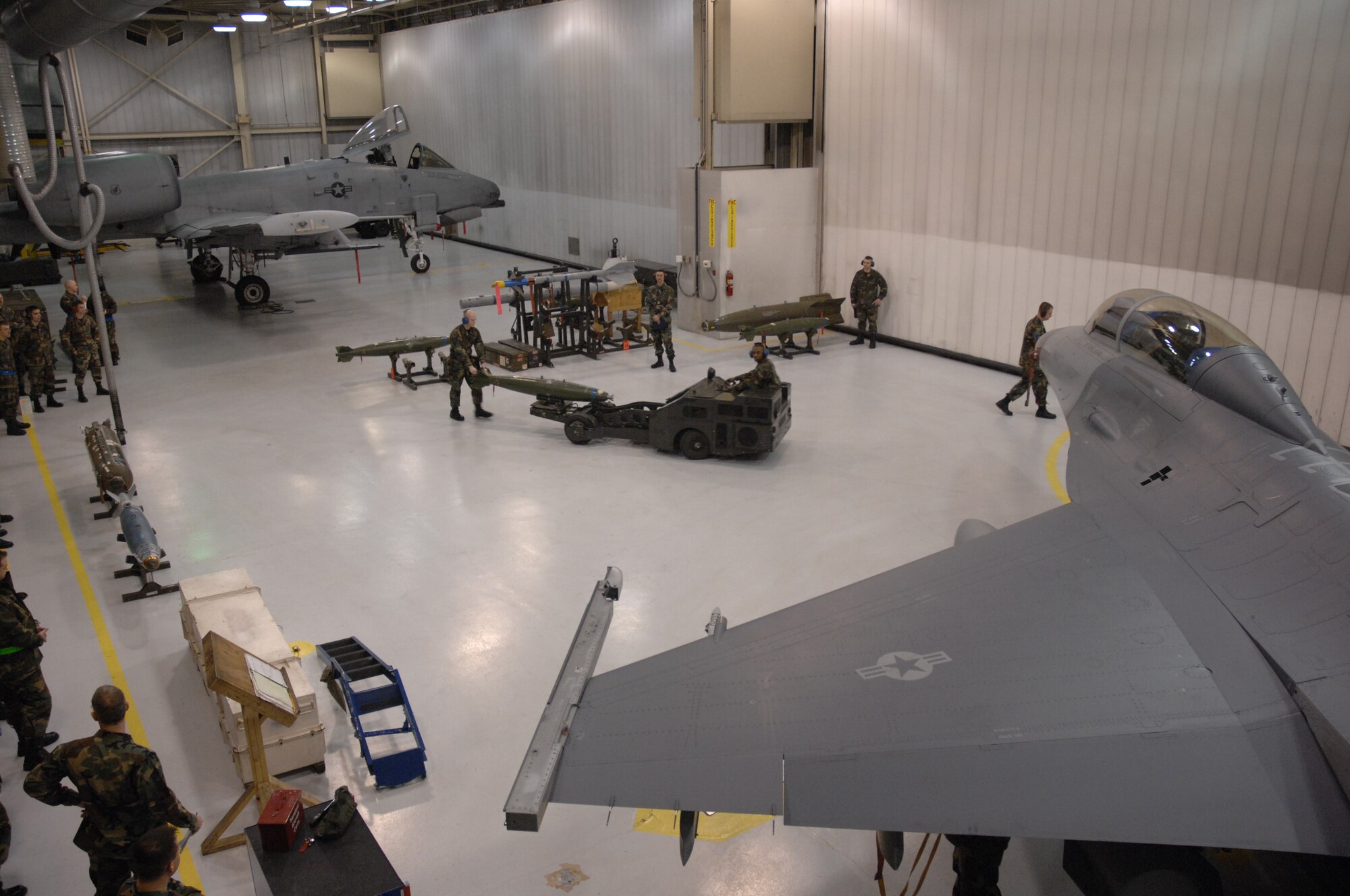 EIELSON AIR FORCE BASE, Alaska -- Staff Sgt Aaron Slay (walking) follows Senior Airman Corneilius Cutler (Jammer driver) while they load a MK-82 bomb on an F-16D Fighting Falcon during the Load Crew of the Quarter contest here on 15 December. The Airmen represent the 18th Aircraft Maintenance Unit (AMU) and the quarterly contest pitts the 18th AMU versus the 355th AMU. Both teams loaded 2 MK-82 low drag bombs and one AIM-9 sidewinder missile to their respective aircraft.
(U.S. Air Force Photo by Staff Sgt Joshua Strang)