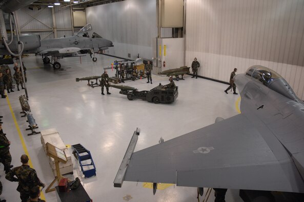 EIELSON AIR FORCE BASE, Alaska -- Staff Sgt Aaron Slay (walking) follows Senior Airman Corneilius Cutler (Jammer driver) while they load a MK-82 bomb on an F-16D Fighting Falcon during the Load Crew of the Quarter contest here on 15 December. The Airmen represent the 18th Aircraft Maintenance Unit (AMU) and the quarterly contest pitts the 18th AMU versus the 355th AMU. Both teams loaded 2 MK-82 low drag bombs and one AIM-9 sidewinder missile to their respective aircraft.
(U.S. Air Force Photo by Staff Sgt Joshua Strang)