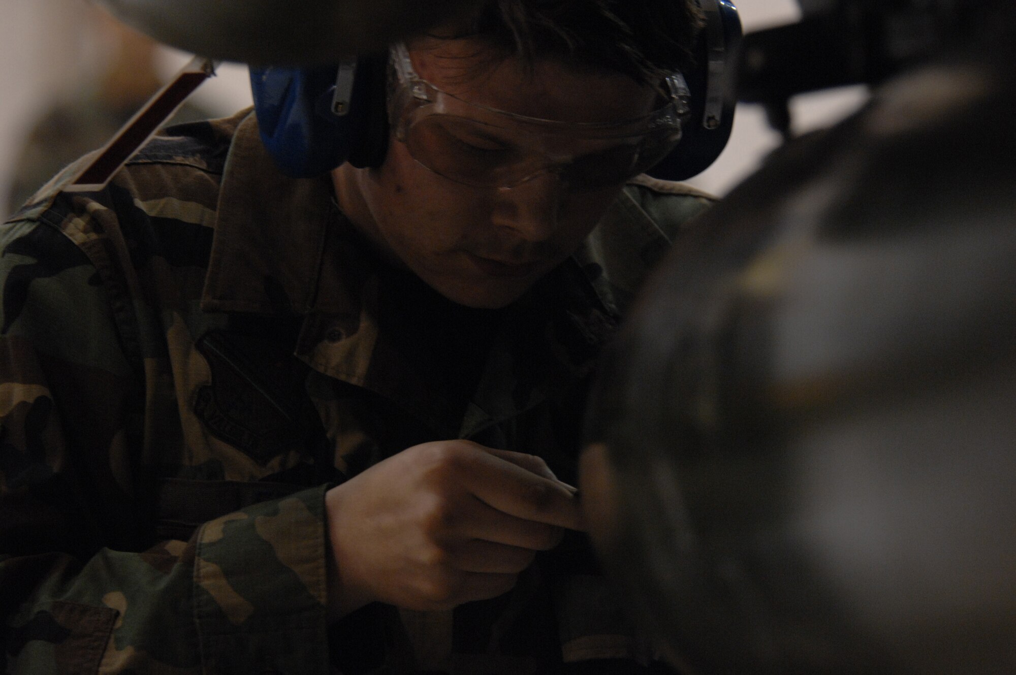 EIELSON AIR FORCE BASE, Alaska -- Senior Airman Michael Lee works on a MK-82 bomb during the Load Crew of the Quarter contest here on 15 December. The Airman represents the 18th Aircraft Maintenance Unit (AMU) and the quarterly contest pitts the 18th AMU versus the 355th AMU. Both teams loaded 2 MK-82 low drag bombs and one AIM-9 sidewinder missile to their respective aircraft.
(U.S. Air Force Photo by Staff Sgt Joshua Strang)