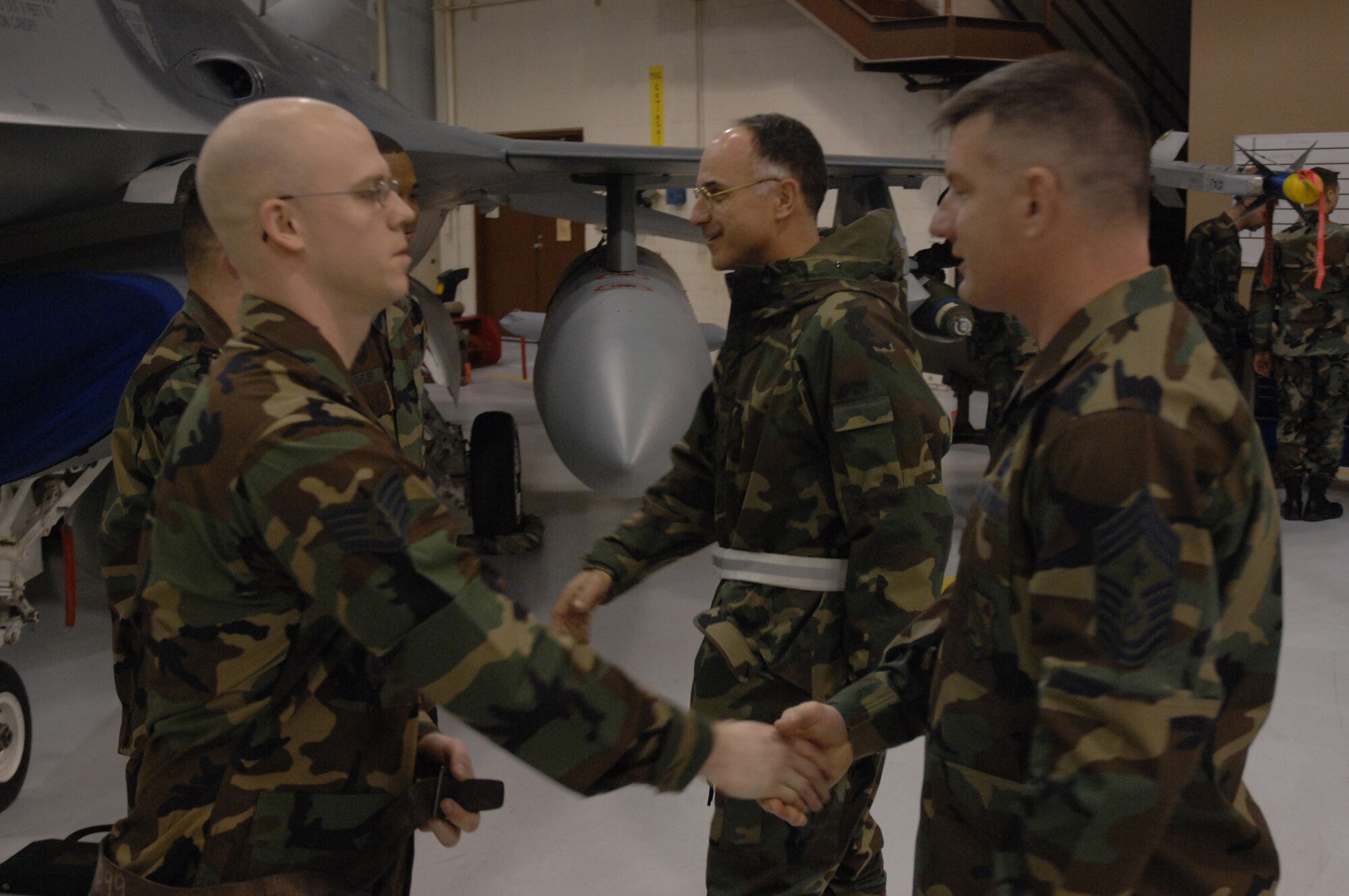 EIELSON AIR FORCE BASE, Alaska -- Brig. Gen. David Scott (middle), Commander, 354 Fighter Wing, and Chief Master Sgt. Stephen Ludwig, Command Chief, 354th Fighter Wing, congratulate the team of Staff Sgt Aaron Slay (front left), Senior Airman Michael Lee and Senior Airman Corneilius Cutler for a job well done after their timed run during the Load Crew of the Quarter contest here on 15 December. The Airmen represent the 18th Aircraft Maintenance Unit (AMU) and the quarterly contest pitts the 18th AMU versus the 355th AMU. Both teams loaded 2 MK-82 low drag bombs and one AIM-9 sidewinder missile to their respective aircraft.
(U.S. Air Force Photo by Staff Sgt Joshua Strang)