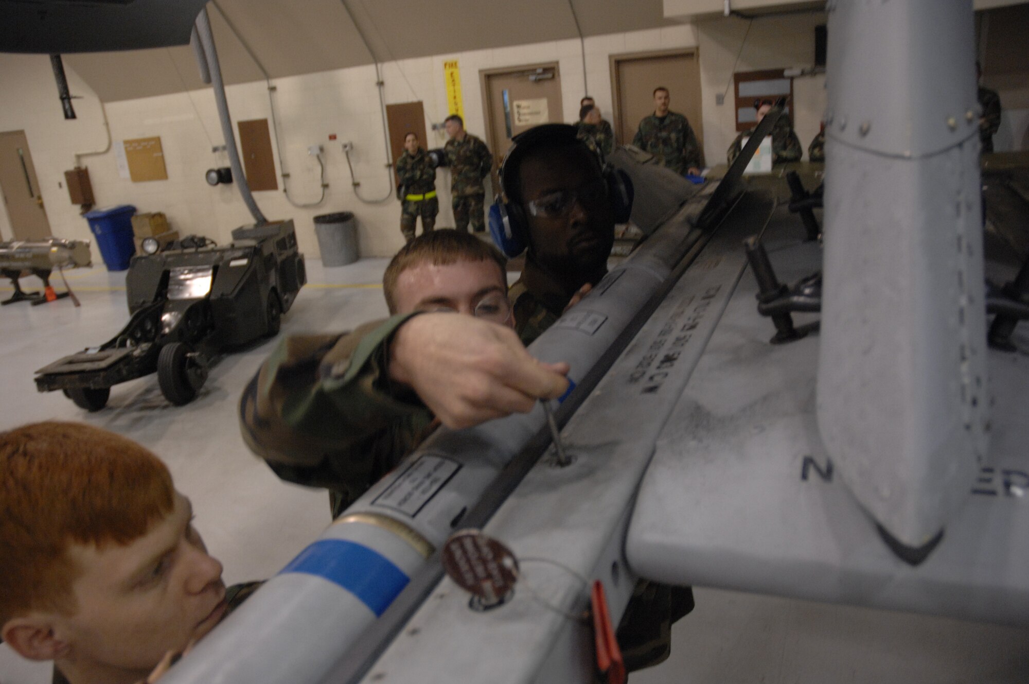 EIELSON AIR FORCE BASE, Alaska -- The team of Staff Sgt Michael Woroniecki (middle), Senior Airman Vankeithin Simmons (right), and Joshua Gess (left) attach a AIM-9 missile to an A-10 Thunderbolt II during the Load Crew of the Quarter contest here on 15 December. The Airmen represent the 355th Aircraft Maintenance Unit (AMU) and the quarterly contest pitts the 18th AMU versus the 355th AMU. Both teams loaded 2 MK-82 low drag bombs and one AIM-9 sidewinder missile to their respective aircraft.
(U.S. Air Force Photo by Staff Sgt Joshua Strang)
