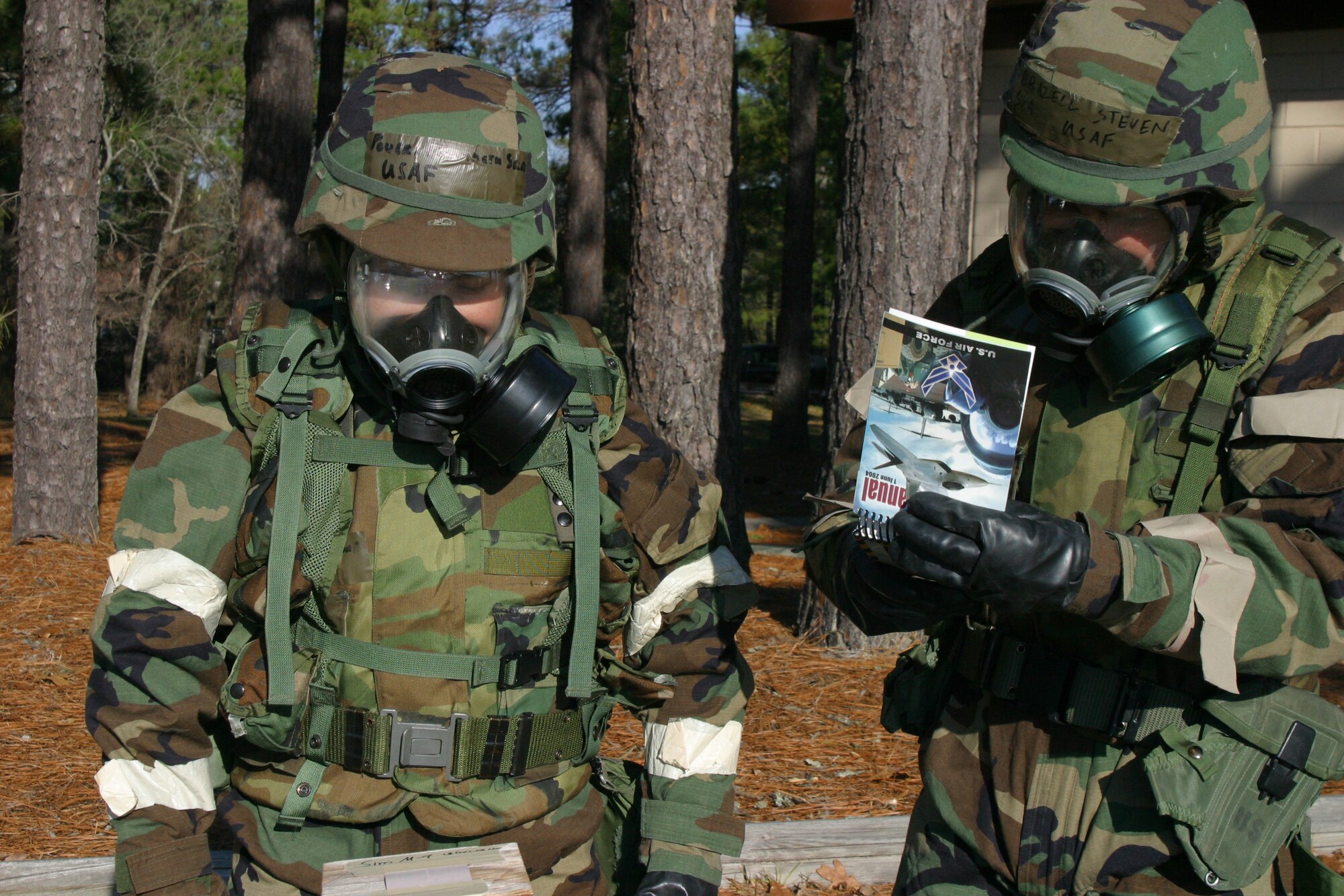 Senior Airmen Elizabeth Powers, left, and Steven Brazell, 43rd Civil Engineer Squadron Readiness Flight, check M-8 paper and refer to their Airman’s Manual during this week’s base exercise. The two Airmen are simulating what they would be doing during a suspected chemical attack.