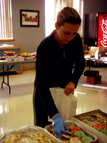 Mrs. Claudia Schnoor, cookie drive volunteer, filled decorated bags with homemade cookies as a special way to show the Airmen living in the dorms that their Air Force family is thinking of them during the holiday season. (U.S. Air Force photo by Airman 1st Class Heather Stanton)