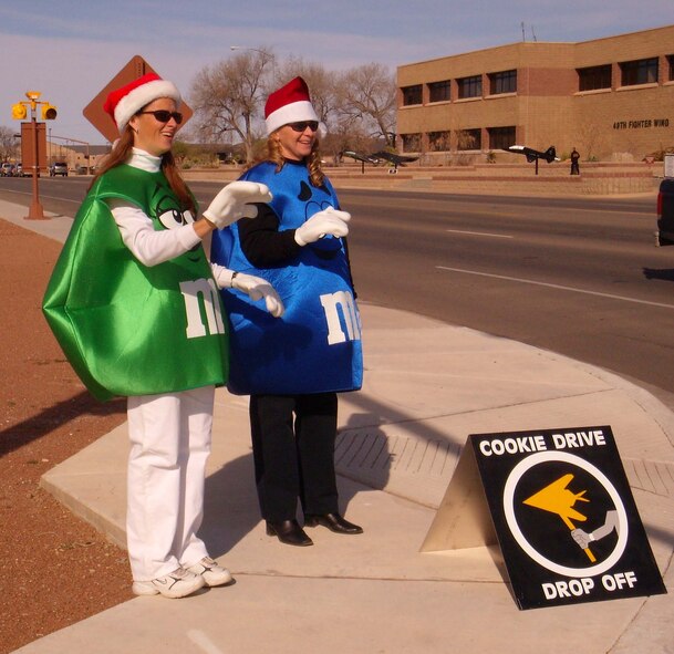 Mrs. Janice Smith and Mrs. Becky McVay, Holloman Officers' Spouses Club members, advertise for the Airmen's Cookie Drive in M&M costumes at the corner of First Street and Arizona Avenue. The drive recieved more than 6,300 cookies for Airmen living in the dorms. (U.S. Air Force photo by Airman 1st Class Heather Stanton)