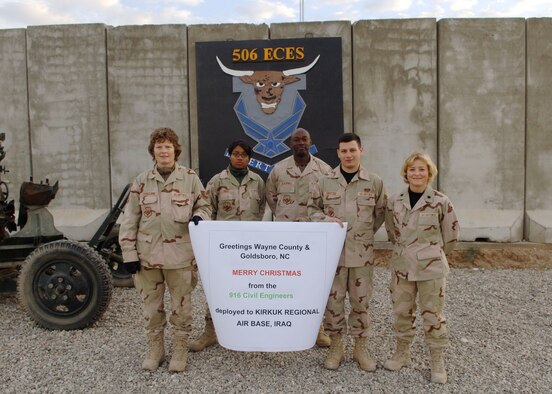 Members of the 916th Air Refueling Wing, Air Force Reserve, send a holiday message home to Goldsboro, N.C. These members of the 916th Civil Engineer Squadron are spending their holidays stationed in Iraq.