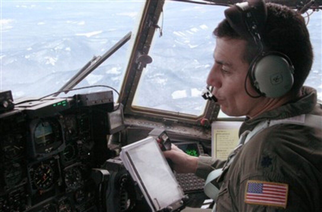 Lt. Col. Caesar Garduno receives coordinates while flying over Mt. Hood, Ore., Dec. 16. Garduno and his Air National Guard crew were joined by an Air Force Reserve pararescueman searching for three missing climbers. 