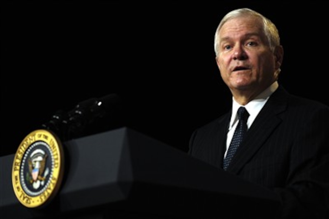 Robert M. Gates addresses the audience as President George W. Bush and Vice President Dick Cheney look on during his oath of office ceremony in the Pentagon on Dec. 18, 2006.  