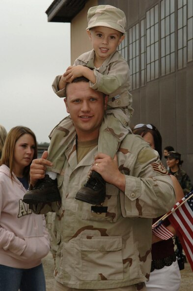 Staff Sgt. Clint Parks walks around with his son C.J. on his shoulders at the homecoming ceremony held for deployed security forces members Dec. 14 at Moody Air Force Base, Ga. More than 160 security forces members returned home just in time to spend the holidays with loved ones. Sergeant Parks is assigned to the 822nd Security Forces Squadron here. (U.S. Air Force photo/Airman 1st Class Elizabeth Rissmiller)