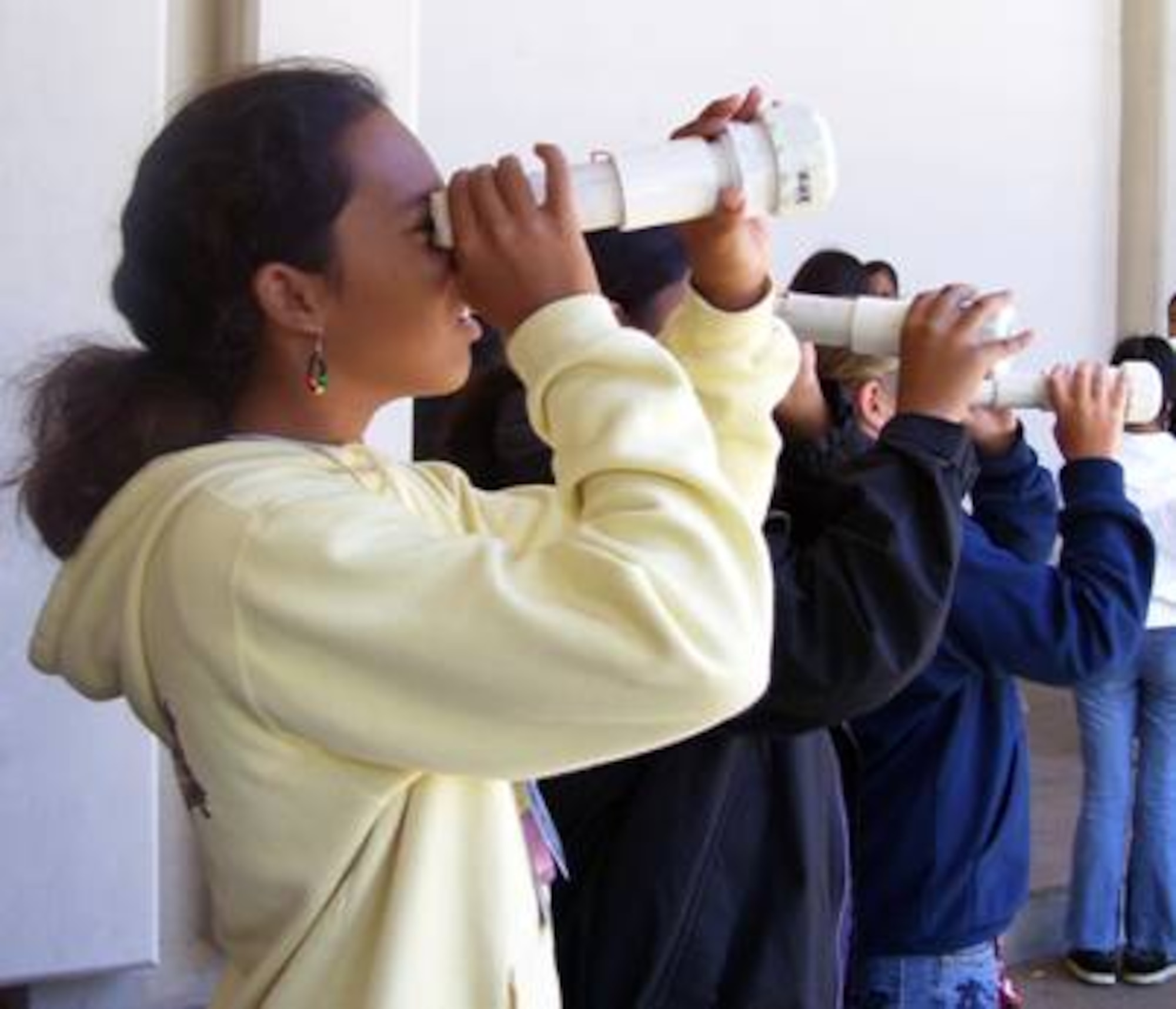 Kulia Murray peers through a PVC telescope she made.  The middle school student was one of 20 who visited the Air Force Research Laboratory’s telescope facilities atop Haleakala, a 10,000-foot-high volcanic mountain on the Hawaiian island of Maui. Their visit was part of a three-day event held earlier this month to expose under-represented groups such as native Hawaiians and Pacific Islanders to careers in science, technology and math.  (Air Force photo)