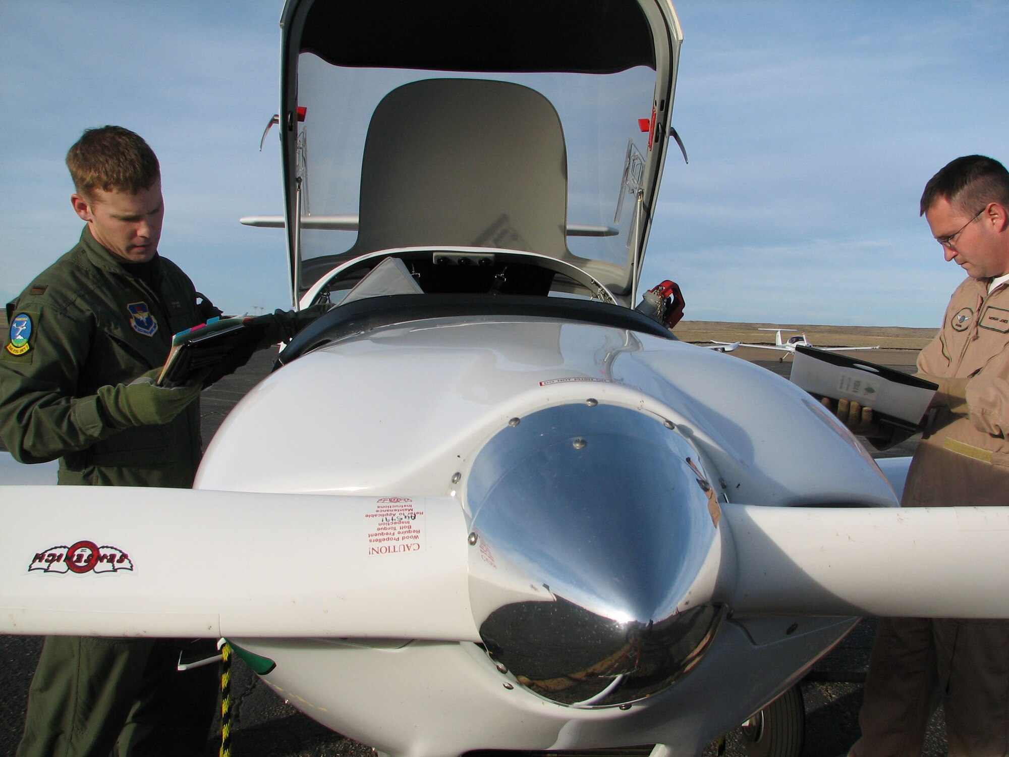 Second Lieutenant John Herd goes over his post-flight checklist with Doss Aviation instructor pilot Morgan Jones Thursday (Dec. 14, 2006) at the Pueblo Memorial Airport in Pueblo, Colo.  Mr. Jones is one of many staff members provided by Doss Aviation as part of a 10-year contract with the Air Force to provide the screening for potential Air Force flyers.  (U.S. Air Force photo by Tech Sgt Mike Hammond)