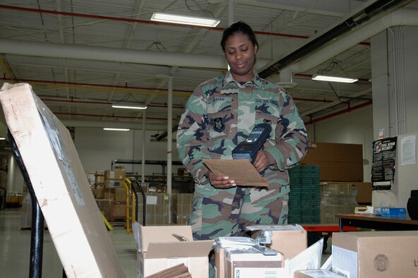YOUNGSTOWN AIR RESERVE STATION, Ohio — Air Force Reserve Senior Airman Aisha Graham, a logistics technician with the 910th Logistics Readiness Squadron, scans a shipment of incoming supply items at the base supply shipping/receiving warehouse here Dec. 19, 2006.  Airman Graham joined the 910th in December 2004 and is attending Akron University pursuing a Bachelor's Degree in Criminal Justice and Political Science.  U.S. Air Force photo/Master Sgt. Bryan Ripple.