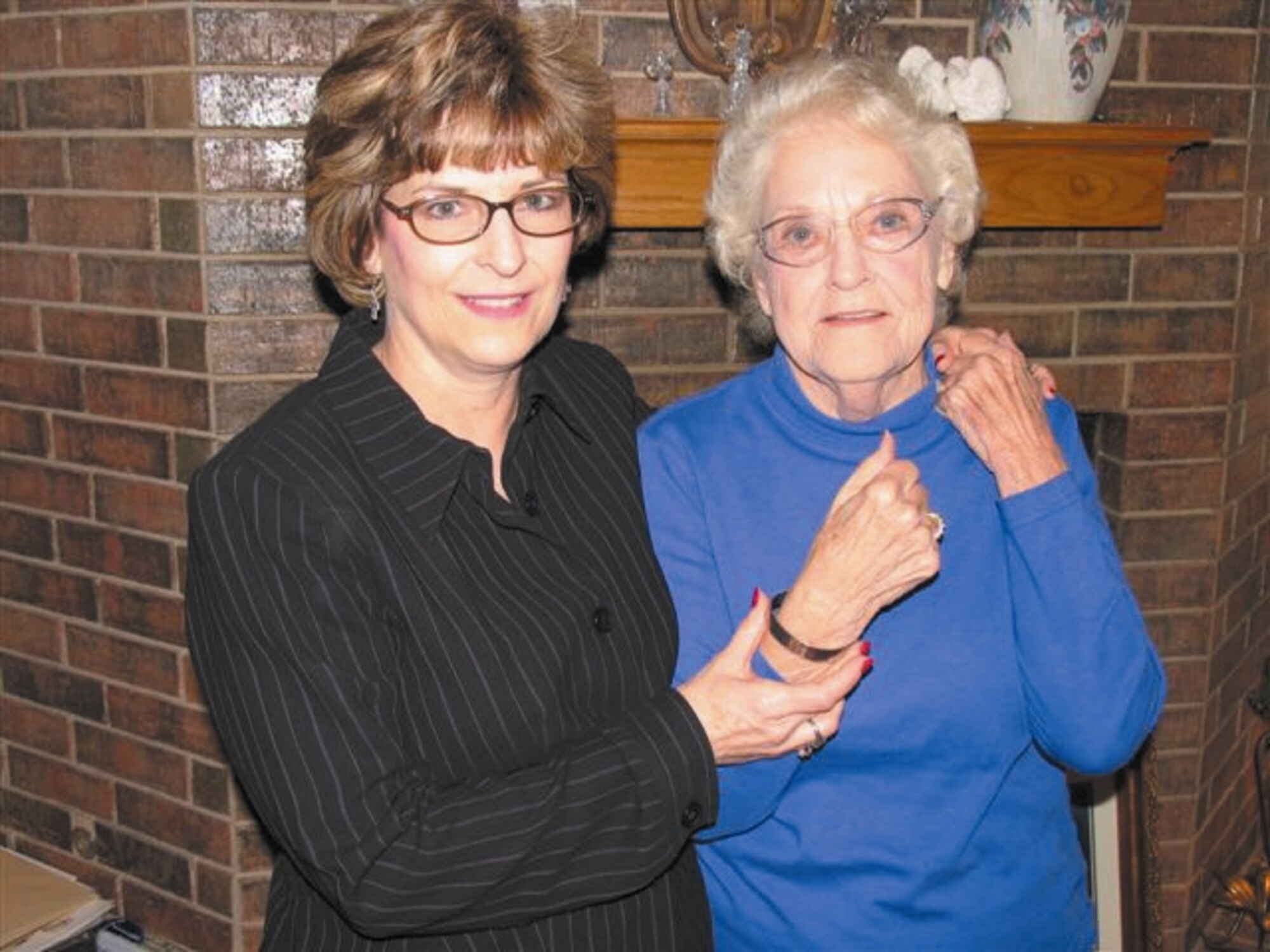 Carol Oakley presents a POW/MIA bracelet bearing the name Maj. Frederick Ransbottom to his mother, Laverne Ransbottom. The major’s remains were recently recovered and identified in Vietnam, ending a 38-year search by his family. (Courtesy photo) 