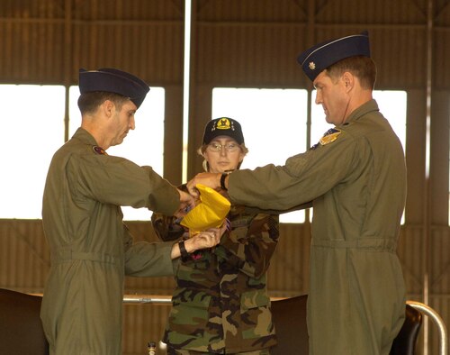 Col. Jack Forsythe, 49th Operations Group commander, and Lt. Col. Chris Knehans, 7th Fighter Squadron commander, roll the guidon of the 7th during the inactivation ceremony Friday. The inactivation of the 7th will be Dec. 31. (U.S. Air Force photo by Airman Michael Means)