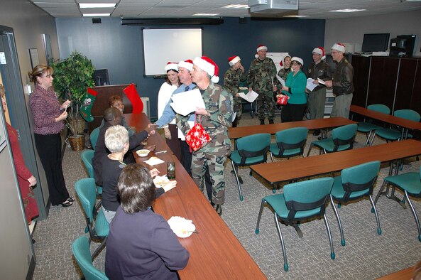 Col. Jay G. Santee, 21st Space Wing Commander, and his band of merry wing-staff elves spent a few hours Dec. 14 sharing holiday cheer.  The caroling crew visited numerous work centers and customer service areas around base, such as; maintenance, support, medical and operations work centers and the MPF and pharmacy.  Colonel Santee sends his holiday greetings to all Team 21 members, those home and deployed, and wishes each of them and their families a safe, happy and prosperous New Year and a safe return. (U.S. Air Force photo by Jeff Bohn)