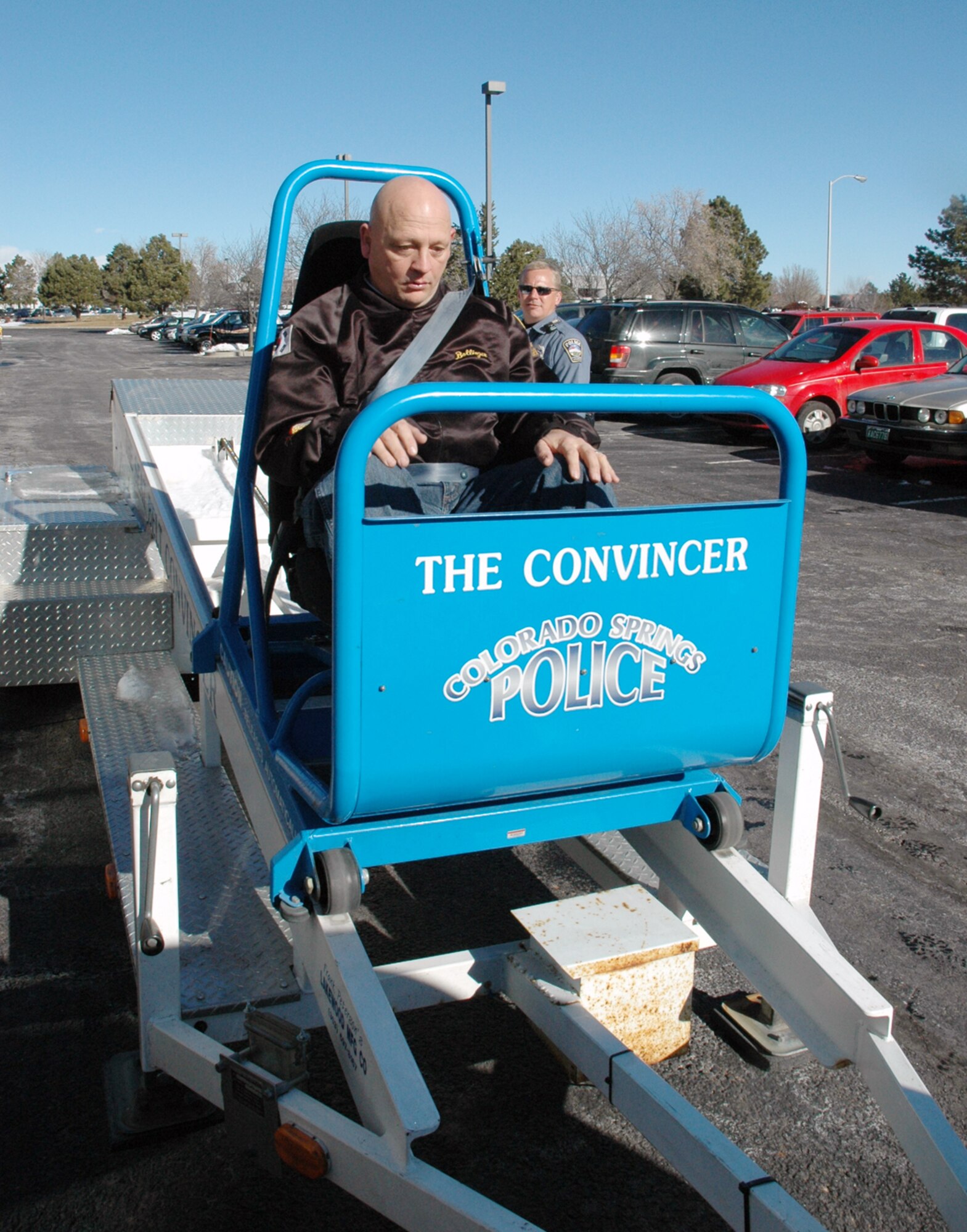 Sgt. 1st Class Harold Bollinger, a missile defense crewman at the 100th MDB, takes a ride in The Convincer, a seatbelt sled that simulates a panic stop without a seatbelt.  The "ride" was offered during the unit's Safety Day.  (Photo by Army Maj. Laura Kenney)