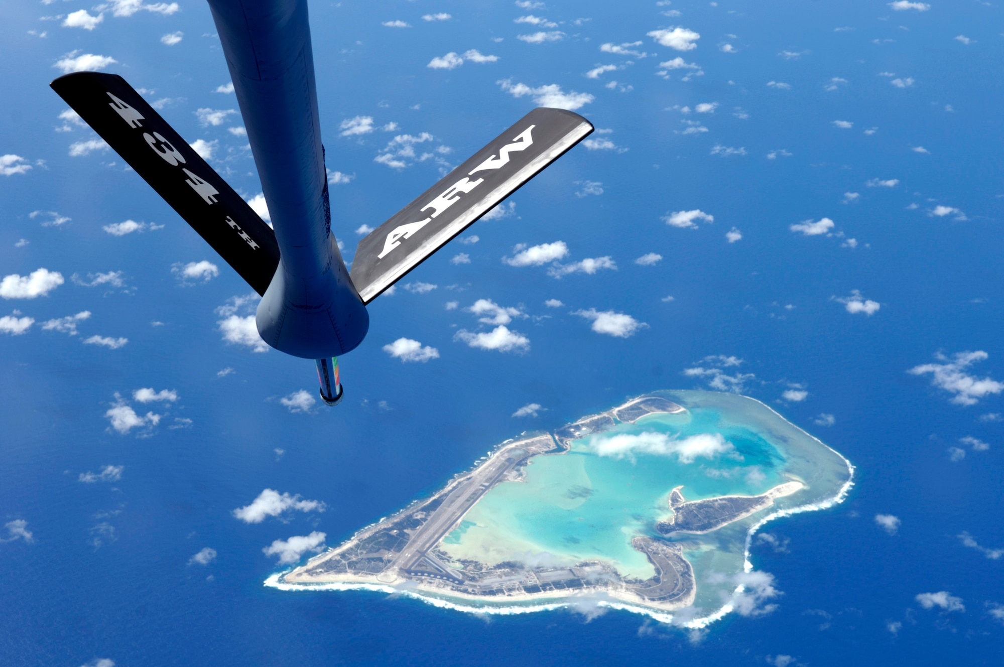 A boom from a KC-135 Stratotanker is visible as it flies Dec. 15 over Wake Island. The KC-135 is from the 74th Air Refueling Squadron, part of the 434th Air Refueling Wing from Grissom Air Force Reserve Base, Ind. Wake Island was devastated by 185 mile per hour winds and a storm surge caused by Super Typhoon Ioke in August of this year. (U.S. Air Force photo/Tech. Sgt. Shane A. Cuomo)