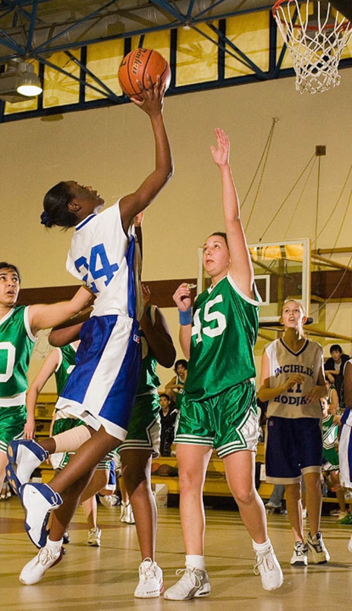 Chantalle Williams goes up for a layup during the girls basketball game against Ankara. The boys and girls Hodjas Basketball Team all won their games against Ankara by more than 40 points. (U.S. Air Force photo by Ismael Gomez)
