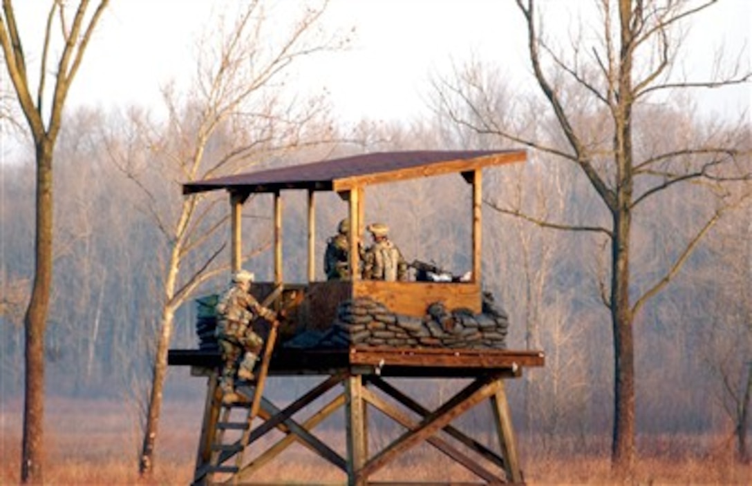 U.S. Army soldiers from the 396th Combat Support Hospital (Forward) man an observation tower, Dec. 13, 2006, on Camp Atterbury, Ind. The soldiers are preparing for a deployment to Afghanistan and are being trained by soldiers with the 205th Infantry Brigade. 