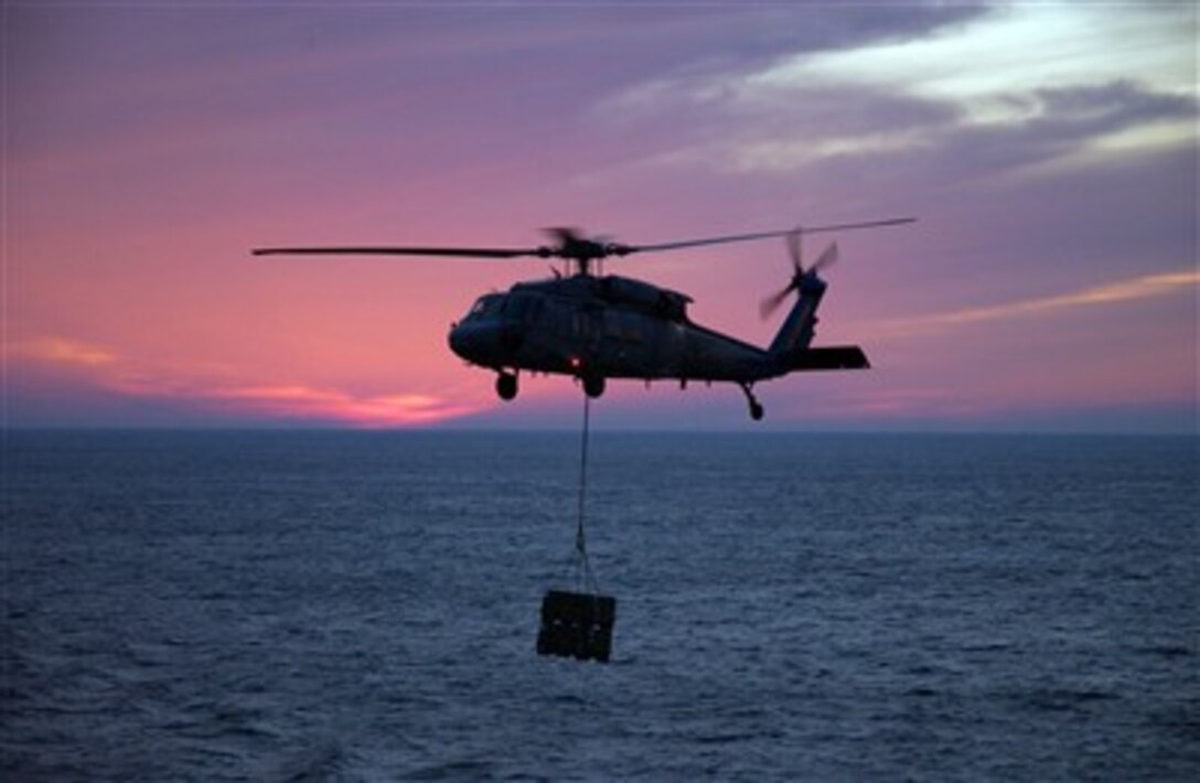 An MH-60 Seahawk helicopter, attached to the Helicopter Sea Combat Squadron 26 "Chargers," prepares to drop supplies aboard the Nimitz-class aircraft carrier USS Theodore Roosevelt in the Atlantic Ocean, Dec. 15, 2006.