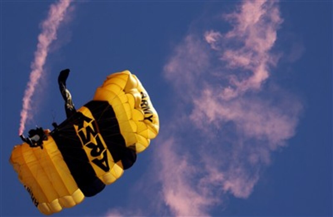 A member of the U.S. Army Golden Knights Parachute Demonstration Team lets out a streak of smoke as he performs a demonstration jump during the 9th Annual Randy Oler Memorial Operation Toy Drop at Fort Bragg, N.C., Dec. 16, 2006.