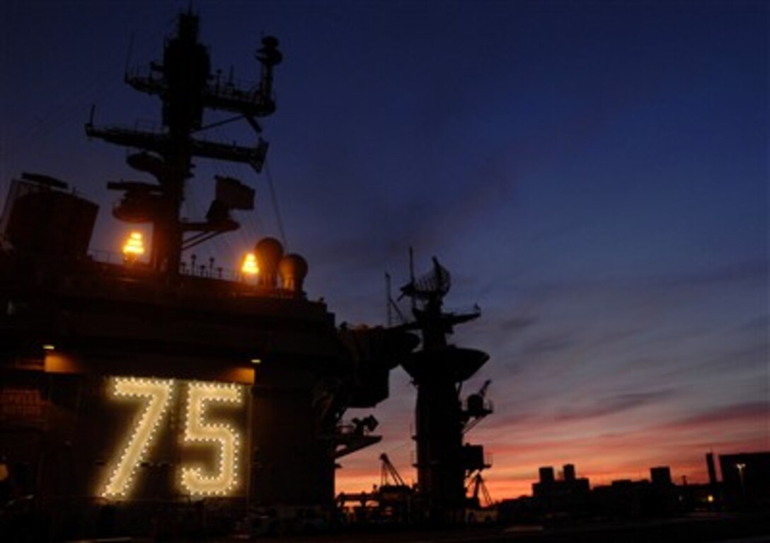 The sun sets beyond the Nimitz-class aircraft carrier USS Harry S. Truman in Portsmouth, Va., Dec. 17, 2006. The Truman is conducting a simulated five-day fast cruise.