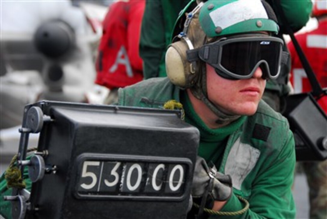 Airman Kyle Sanders confirms the weight of an F/A-18E Super Hornet prior to launch aboard the nuclear-powered aircraft carrier USS Nimitz  in the Pacific Ocean, Dec. 15, 2006. The Nimitz is under way off the coast of Southern California. 