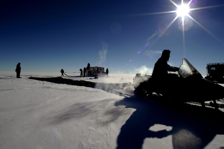 SOUTH POLE -- Members of the National Science Foundation work to retrieve their supplies after a C-17 Globemaster III airdropped supplies to them Dec. 20, 2006. Staffed by Airmen from McChord Air Force Base's 62nd and 446th Airlift Wings, the crew delivered 70 tons of supplies to the NSF. The mission was a "proof of concept" flight. 
(U.S. Antarctic Program/Forest Banks)