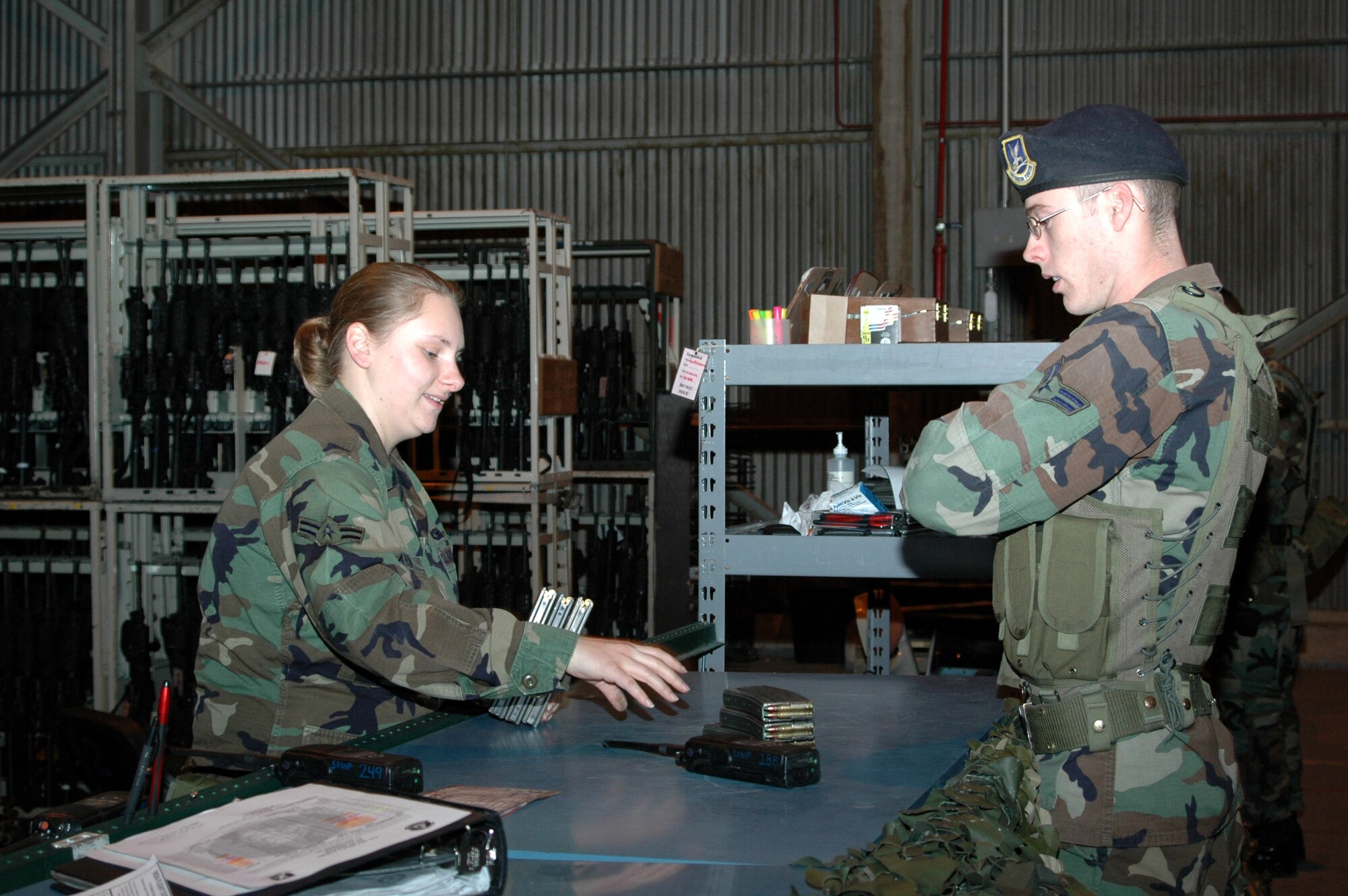 Airman 1st Class Amber Roaten, an armorer with the 341st Security Support Squadron at Malmstrom Air Force Base, Mont., accepts ammunition turned in by a security forces member after his shift Dec. 8. (U.S. Air Force photo/Amn. Emerald Ralston)