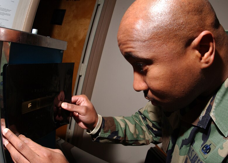 EIELSON AIR FORCE BASE, Alaska -- Technical Sgt. Gianni Hollomon, 354 Maintenance Squadron, inspects an x-ray of a weld for any cracks and incomplete fusions on Dec. 19. He is reviewing this x-ray for part of Senior Airman Daronn Rawlins (Not Shown) training certification for level two welding. Once he has the certification, he can now weld Aircraft and Missile parts. 
(U.S. Air Force Photo by Airman Jonathan Snyder) 