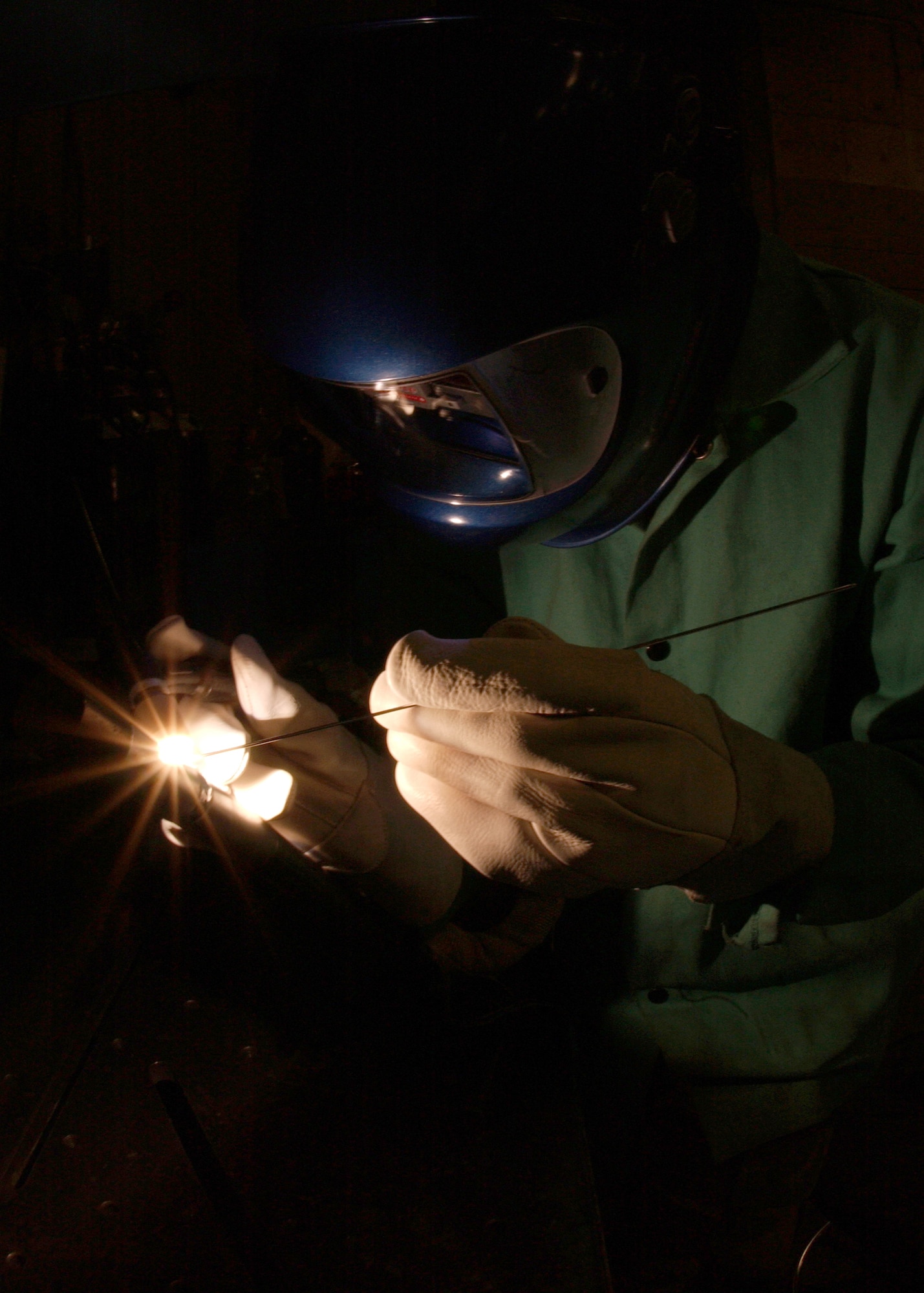 EIELSON AIR FORCE BASE, Alaska -- Senior Airman Daronn Rawlins, 354 Maintenance Squadron, Aircraft Metal Technology Section, uses a Tungsten Inherit Gas welder and a Filler Rod too fuse two Aluminum tubes together on Dec. 19. He has been training for about a month now for his welding certification level two. Some of the requirements he must accomplish are to weld Titanium, Stainless Steel, Aluminum, Nickel, and Cobalt tubes together. Once he obtains certification for level two welding he can now weld Aircraft parts and Missile parts. 
(U.S. Air Force Photo by Airman Jonathan Snyder) 