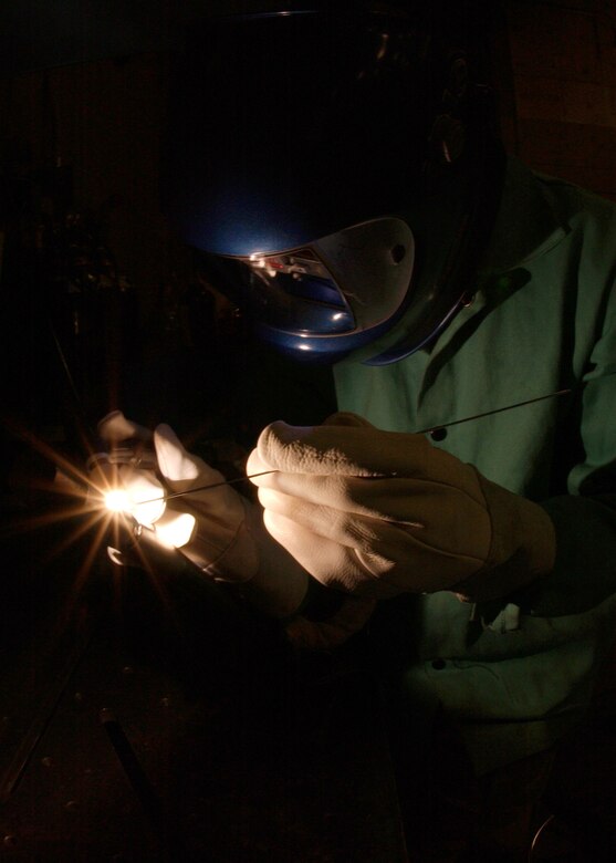 EIELSON AIR FORCE BASE, Alaska -- Senior Airman Daronn Rawlins, 354 Maintenance Squadron, Aircraft Metal Technology Section, uses a Tungsten Inherit Gas welder and a Filler Rod too fuse two Aluminum tubes together on Dec. 19. He has been training for about a month now for his welding certification level two. Some of the requirements he must accomplish are to weld Titanium, Stainless Steel, Aluminum, Nickel, and Cobalt tubes together. Once he obtains certification for level two welding he can now weld Aircraft parts and Missile parts. 
(U.S. Air Force Photo by Airman Jonathan Snyder) 