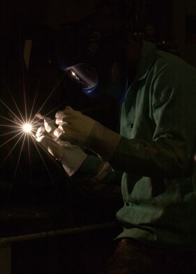EIELSON AIR FORCE BASE, Alaska -- Senior Airman Daronn Rawlins, 354 Maintenance Squadron, Aircraft Metal Technology Section, uses a Tungsten Inherit Gas welder and a Filler Rod too fuse two Aluminum tubes together on Dec. 19. He has been training for about a month now for his welding certification level two. Some of the requirements he must accomplish are to weld Titanium, Stainless Steel, Aluminum, Nickel, and Cobalt tubes together. Once he obtains certification for level two welding he can now weld Aircraft parts and Missile parts. 
(U.S. Air Force Photo by Airman Jonathan Snyder) 
