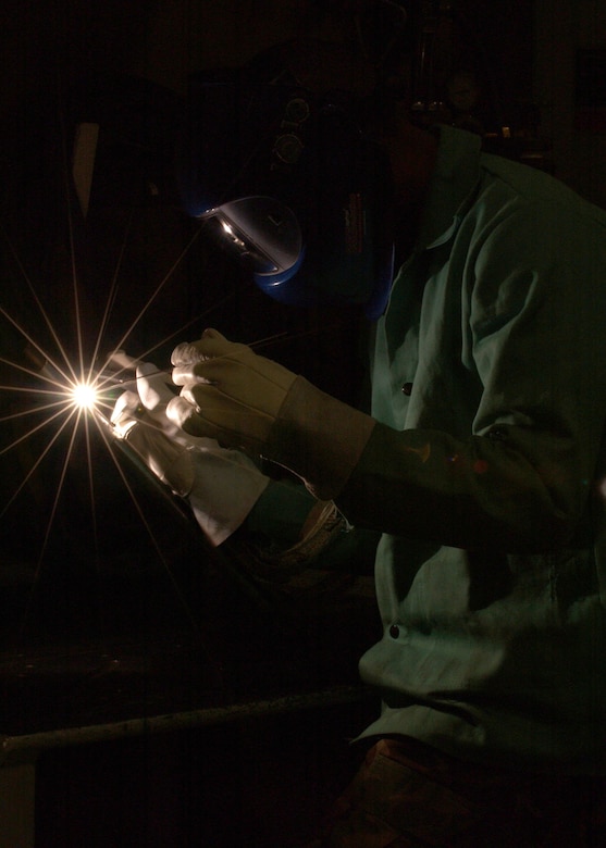 EIELSON AIR FORCE BASE, Alaska -- Senior Airman Daronn Rawlins, 354 Maintenance Squadron, Aircraft Metal Technology Section, uses a Tungsten Inherit Gas welder and a Filler Rod too fuse two Aluminum tubes together on Dec. 19. He has been training for about a month now for his welding certification level two. Some of the requirements he must accomplish are to weld Titanium, Stainless Steel, Aluminum, Nickel, and Cobalt tubes together. Once he obtains certification for level two welding he can now weld Aircraft parts and Missile parts. 
(U.S. Air Force Photo by Airman Jonathan Snyder) 