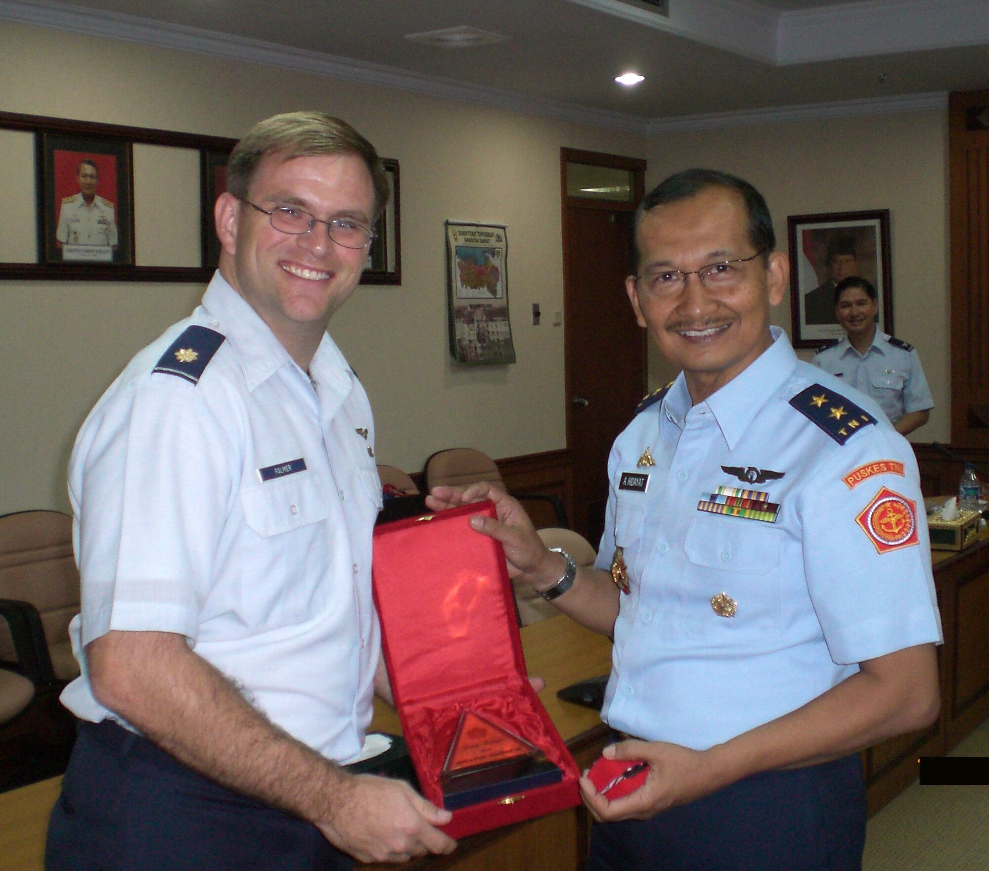 JAKARTA -- Pacific Air Forces' International Health Affairs member, Maj Wesley Palmer, is presented a token of appreciation from Surgeon General of the Armed Forces of Indonesia, Air Vice Marshal (Dr.) A. Hidayatand.  Palmer was a guest speakers at the Indonesian Air Force's First "Jakarta International Aerospace Medicine Symposium". In attendance were over 200 delegates from 5 countries.  (Photo courtesy of IHA)