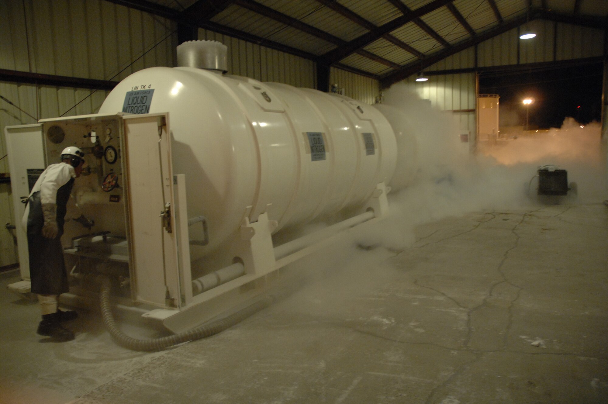 EIELSON AIR FORCE BASE, Alaska -- Airman First Class Andrew Tuttle, 354th Logistics Readiness Squadron, purges the Liquid Nitrogen (LIN) tube to clear any impurities that may have settled since its last use. The plume is the result of burnoff and the extremely low boiling point of the LIN.
(U.S. Air Force Photo by Staff Sgt Joshua Strang)