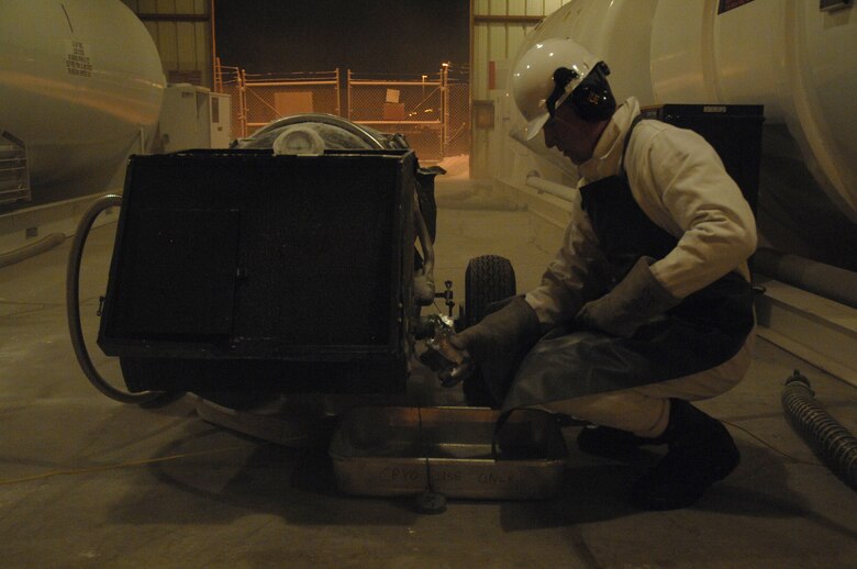 EIELSON AIR FORCE BASE, Alaska -- Airman First Class Andrew Tuttle, 354th Logistics Readiness Squadron, fills a test jar with Liquid Oxygen (LOX) here Dec 20 during an odor particulate sample test. The LOX is used as the breathing oxygen in aircraft and a test is conducted before every LOX cart is filled to ensure pilots only receive good oxygen.
(U.S. Air Force Photo by Staff Sgt Joshua Strang)