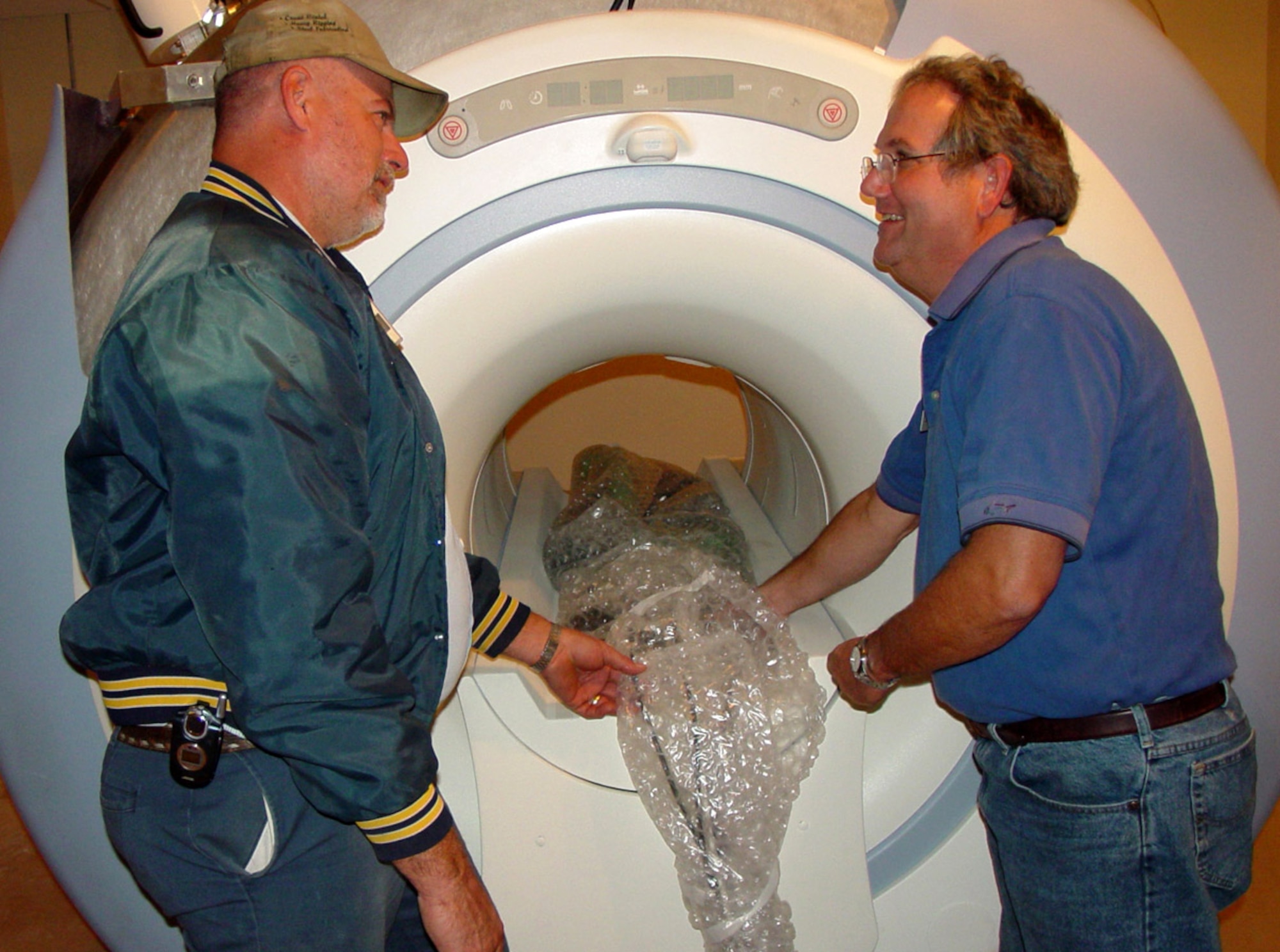 Gary Chambliss and Michael Alexander discuss the project to install Keesler Medical Center's new magnetic resonance imaging system Dec. 7 at Keesler Air Force Base, Miss. Caffey, Inc., crews look to install and have the system up and running in January, about half the time it normally takes to install similar equipment. Mr. Chambliss is superintendent for Caffey, Inc. Mr. Alexander is project manager for installations for General Electric Healthcare Technologies. (U.S. Air Force photo/Steve Pivnick)