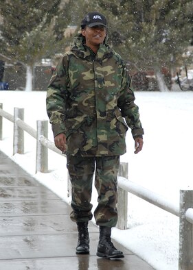 Master Sgt. Kyshia Newsome, Air Force Research Laboratory, walks to the base exchange here Tuesday during the snow storm the base and surrounding areas received. The installation commander authorized early release of nonessential personnel Tuesday and closed the base to nonessential personnel Wednesday. (U.S. Air Force photo by Todd Berenger)