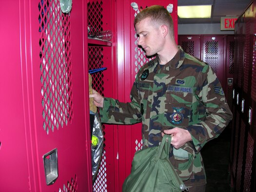 Senior Airman Alan Leckie checks his gear after coming on shift at the fire department at Hickam Air Force Base, Hawaii. Airman Leckie, assigned to the 15th Civil Engineer Squadron, will work on Christmas Day to ensure the base is safe. (U.S. Air Force photo/2nd Lt. Melanie McLean)
