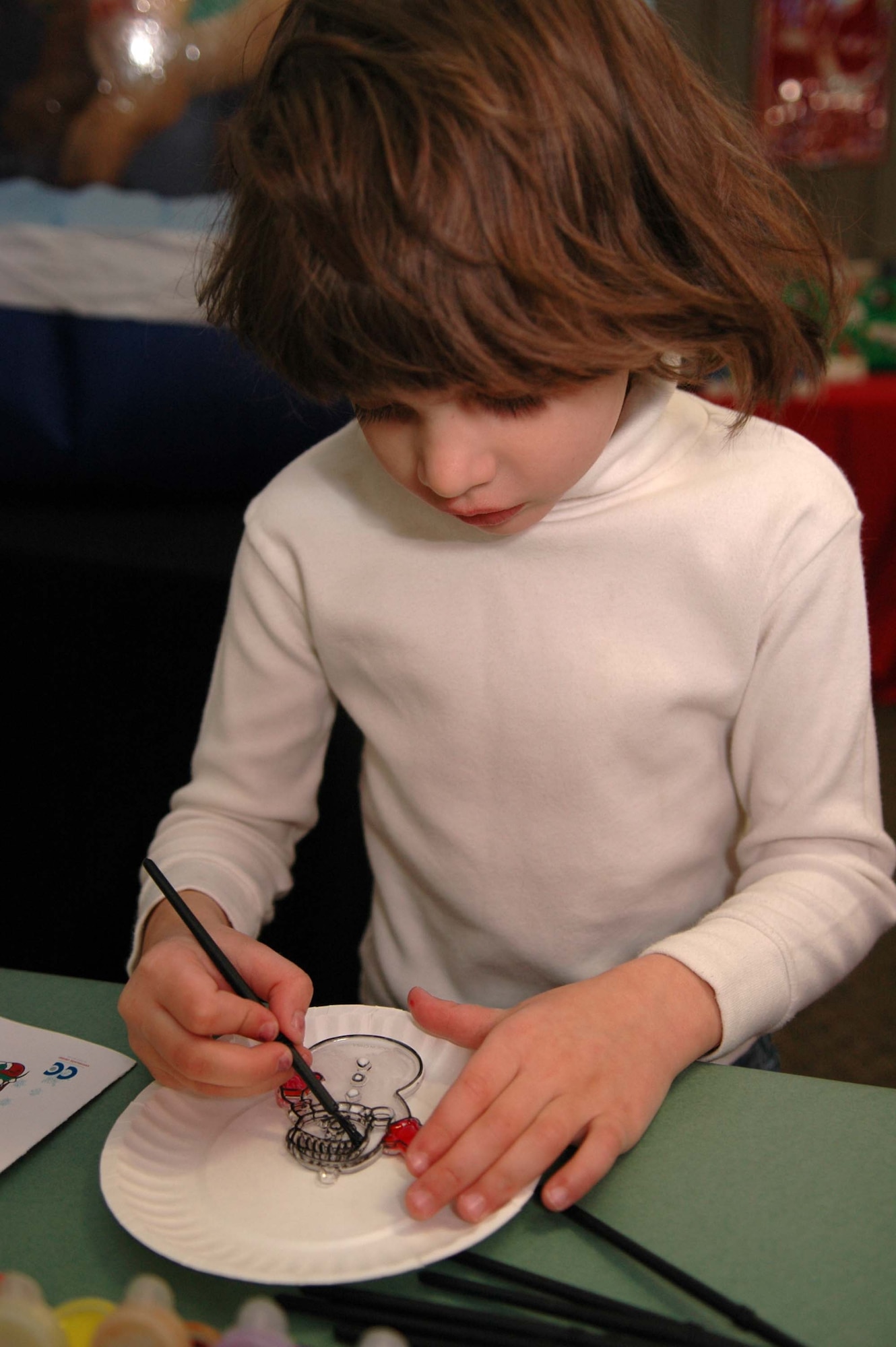 Sierra Dessino, 5, decorates a snowman ornament at the Children's International Festival Saturday. (U.S. photo by Airman Jamal Sutter)