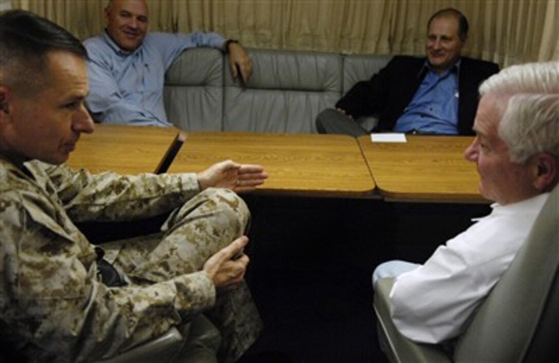 U.S. Marine Gen. Peter Pace, chairman of the Joint Chiefs of Staff, speaks with Defense Secretary Robert Gates, right, on board a C-17 en route to Iraq, while Robert Rangel, special assistant to the secretary of defense, and Eric Edelman, under secretary of defense for policy, look on, Dec. 19, 2006.