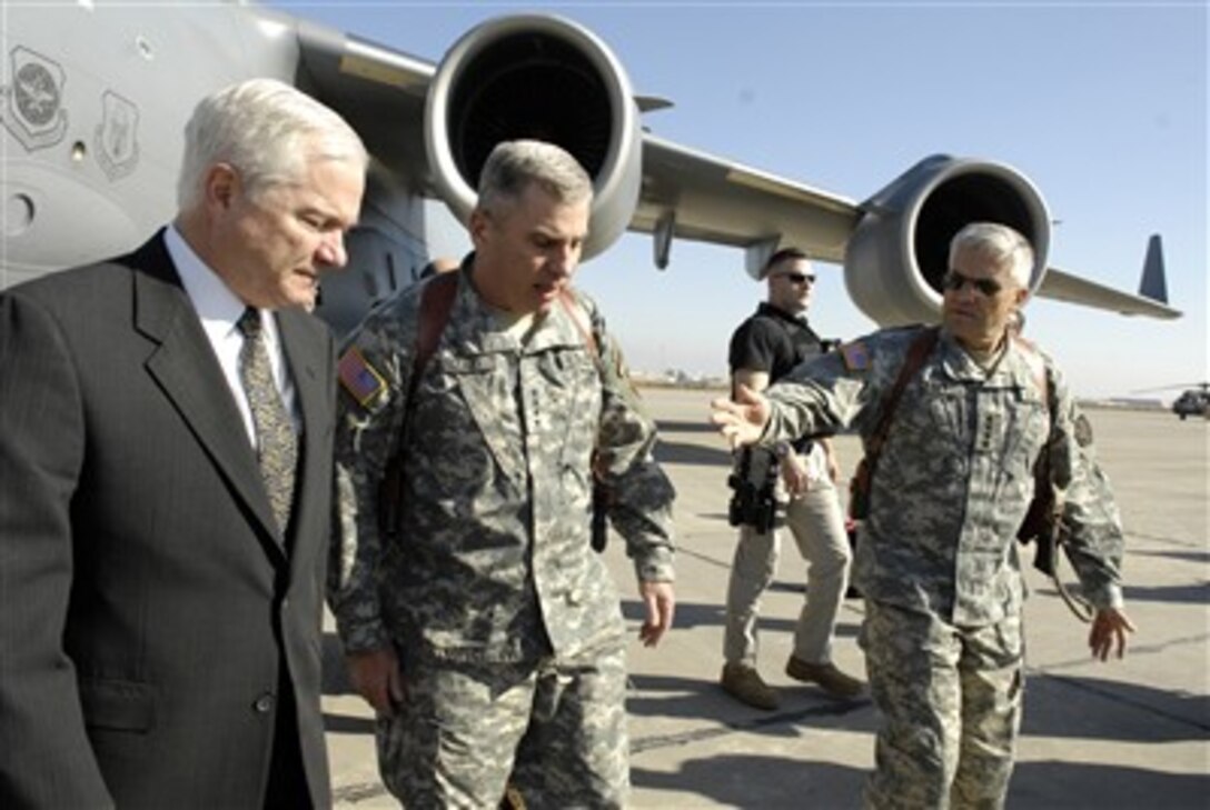 Defense Secretary Robert Gates is greeted at the aircraft by Gen. John Abizaid, center, commander of U.S. Central Command, and Gen. George Casey, commander of Multinational Forces-Iraq, upon his arrival in Baghdad, Iraq, Dec. 20, 2006.