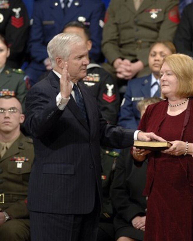 Becky Gates (right) holds the bible as Robert M. Gates is sworn in as the 22nd secretary of defense by Vice President Dick Cheney in the Pentagon on Dec. 18, 2006. 