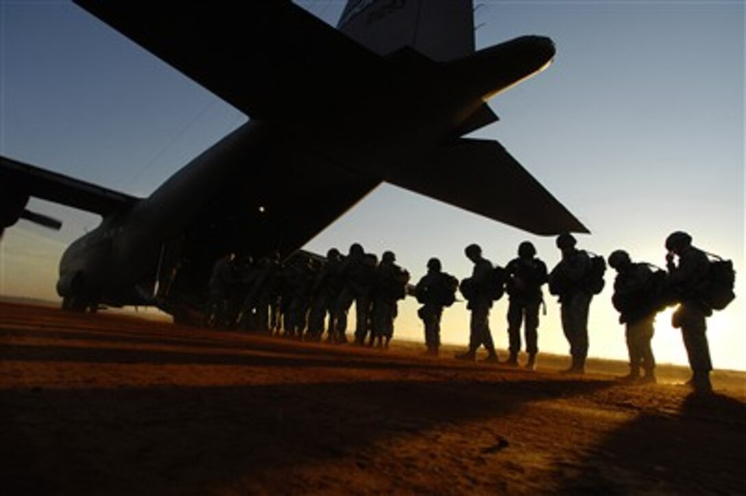U.S. Army paratroopers board a C-130 Hercules aircraft during the 9th Annual Randy Oler Memorial Operation Toy Drop at Fort Bragg, N.C., on Dec. 16, 2006. Soldiers donated a toy in exchange for a chance to make a non-tactical, training parachute jump with German or Australian jumpmasters.  Since its inception, Operation Toy Drop has collected and distributed more than 20,000 toys for families of soldiers and for local orphanages.  
