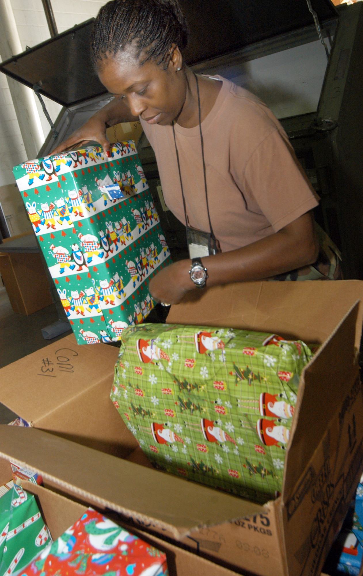 Maj. Gwen Taylor, 116th Logistics Readiness Squadron operations manager, packs presents into boxes to be distributed to families.
U.S. Air Force photo by SUE SAPP